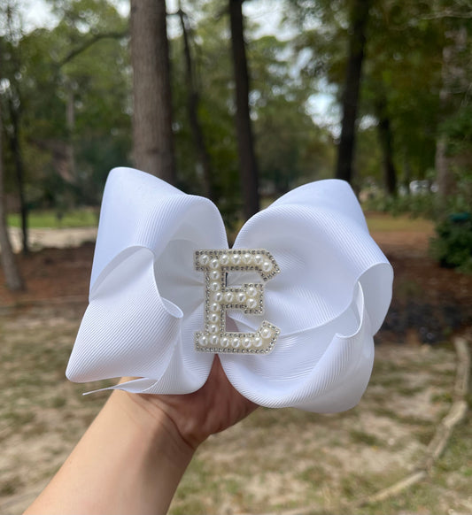 White ribbon bow with letter emblem